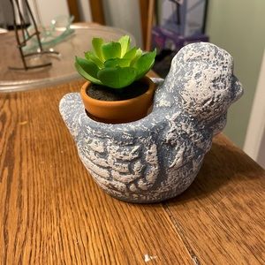 Repurposed hen planter with faux succulent.